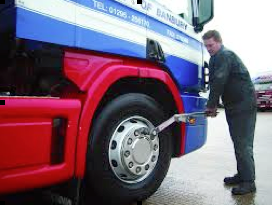 mechanic using a bus torque wrench